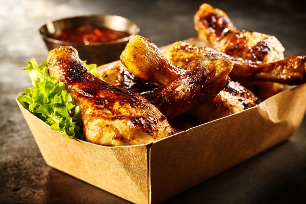 Takeaway box of crispy grilled chicken legs
