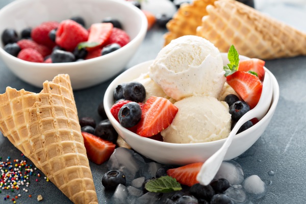 Vanilla ice cream scoops with berries The Surprising Health Benefits of Eating Ice Cream