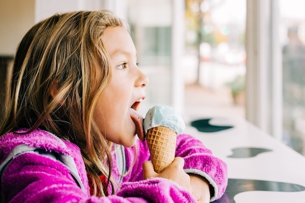 girl enjoying ice cream wearing fleece